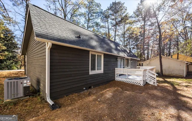 a view of a house with a yard and wooden fence