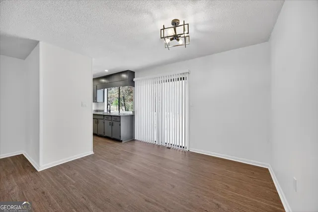 a view of a room with wooden floor and window