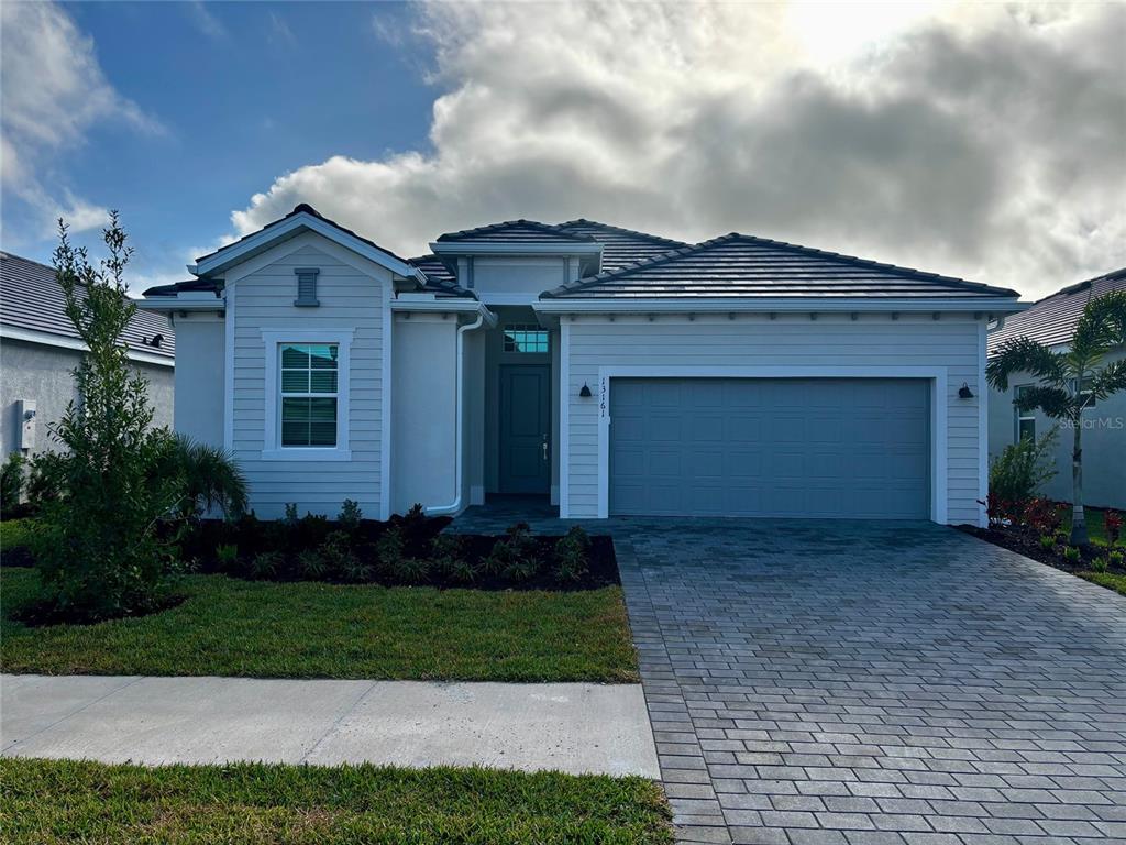 13161 Tulum Loop Venice, FL 34293 - Photo 1 of 1 a front view of a house with a garden