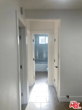 a bathroom with a glass shower door and a sink