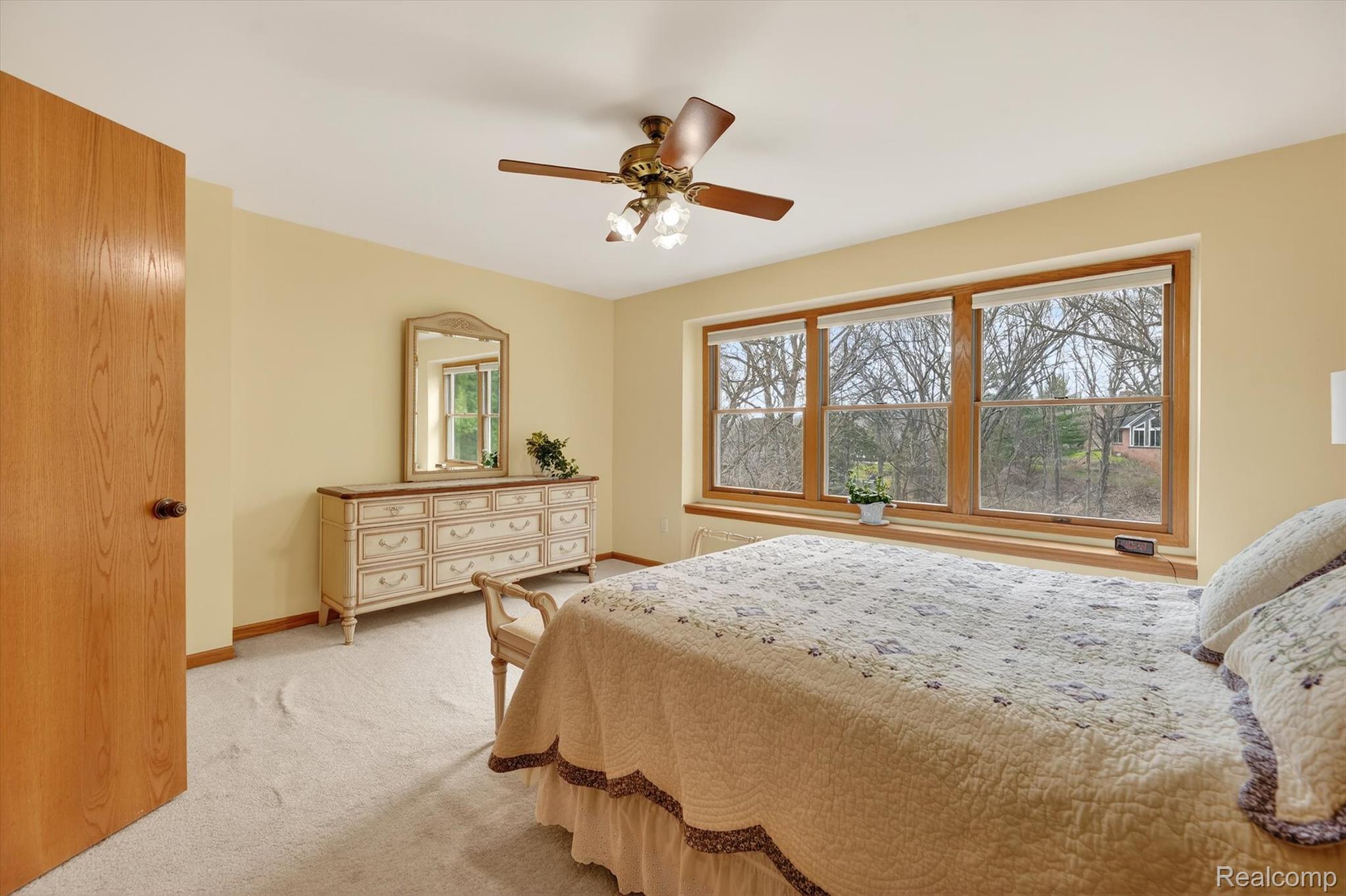 7798 Lee Road Brighton, MI 48116 - Photo 25 of 49 Bedroom featuring a ceiling fan and light colored carpet