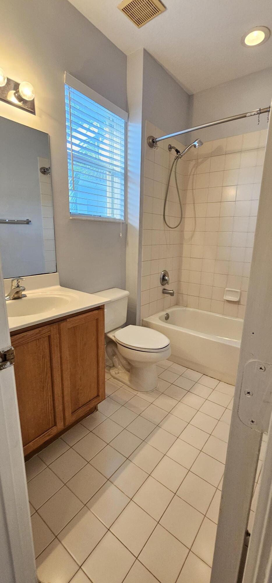 3078 Laurel Ridge Circle Riviera Beach, FL 33404 - Photo 11 of 13 a bathroom with a granite countertop sink toilet and shower