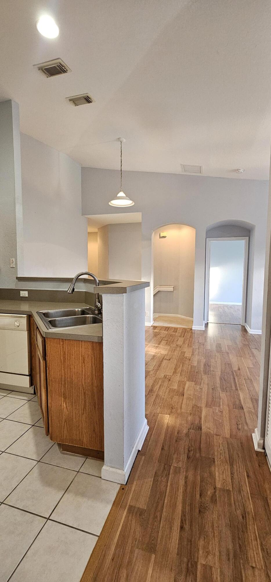 3078 Laurel Ridge Circle Riviera Beach, FL 33404 - Photo 6 of 13 a kitchen with stainless steel appliances granite countertop a stove a sink and a refrigerator