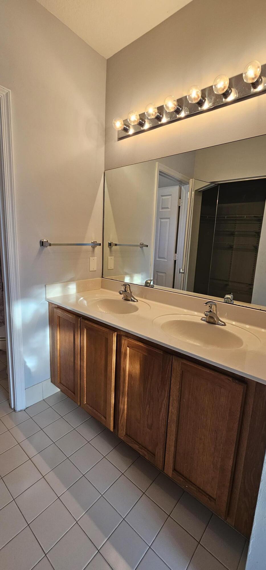 3078 Laurel Ridge Circle Riviera Beach, FL 33404 - Photo 8 of 13 a bathroom with a sink and a mirror