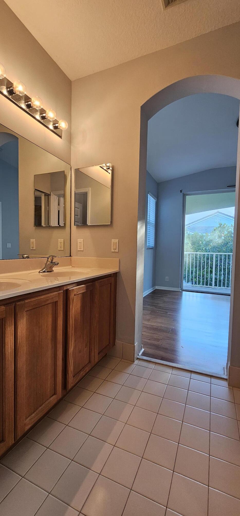 3078 Laurel Ridge Circle Riviera Beach, FL 33404 - Photo 9 of 13 a bathroom with a sink and a mirror