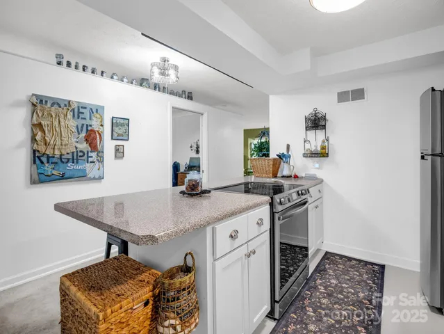 a kitchen with stainless steel appliances granite countertop a stove and a sink