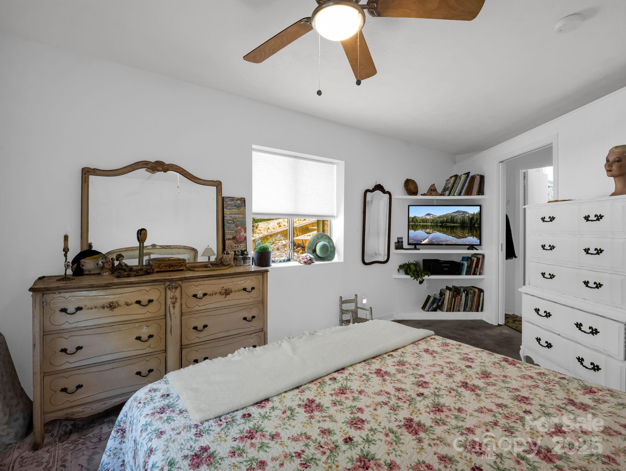 305 Grady Avenue Tryon, NC 28782 - Photo 20 of 24 a bedroom with a bed and a flat tv screen on dresser