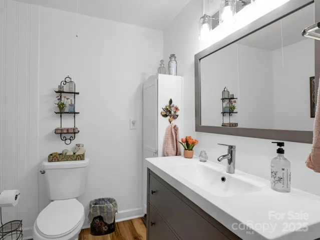 a bathroom with a sink toilet and mirror