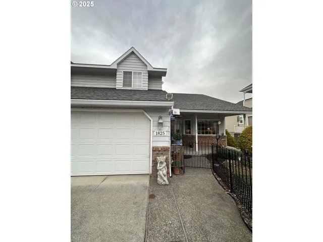 a view of a house with a garage and a barbeque