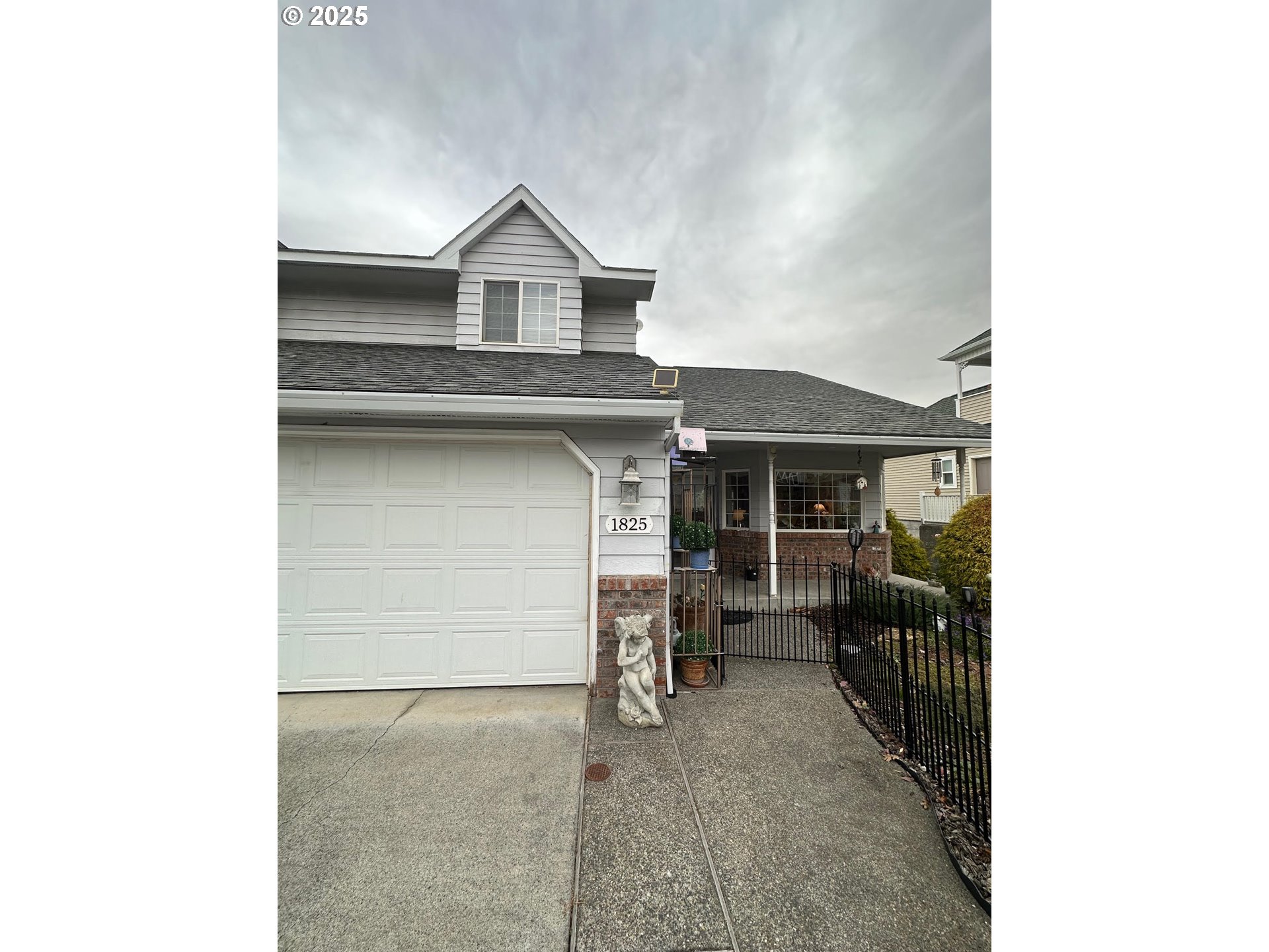 a view of a house with a garage and a barbeque