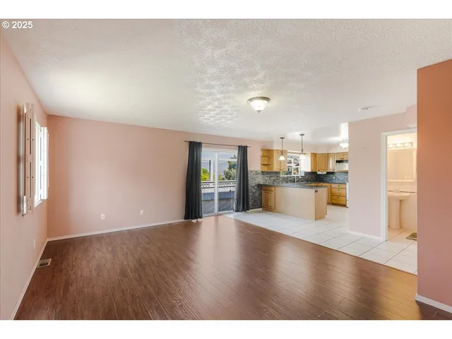 a view of a kitchen with a sink and a window