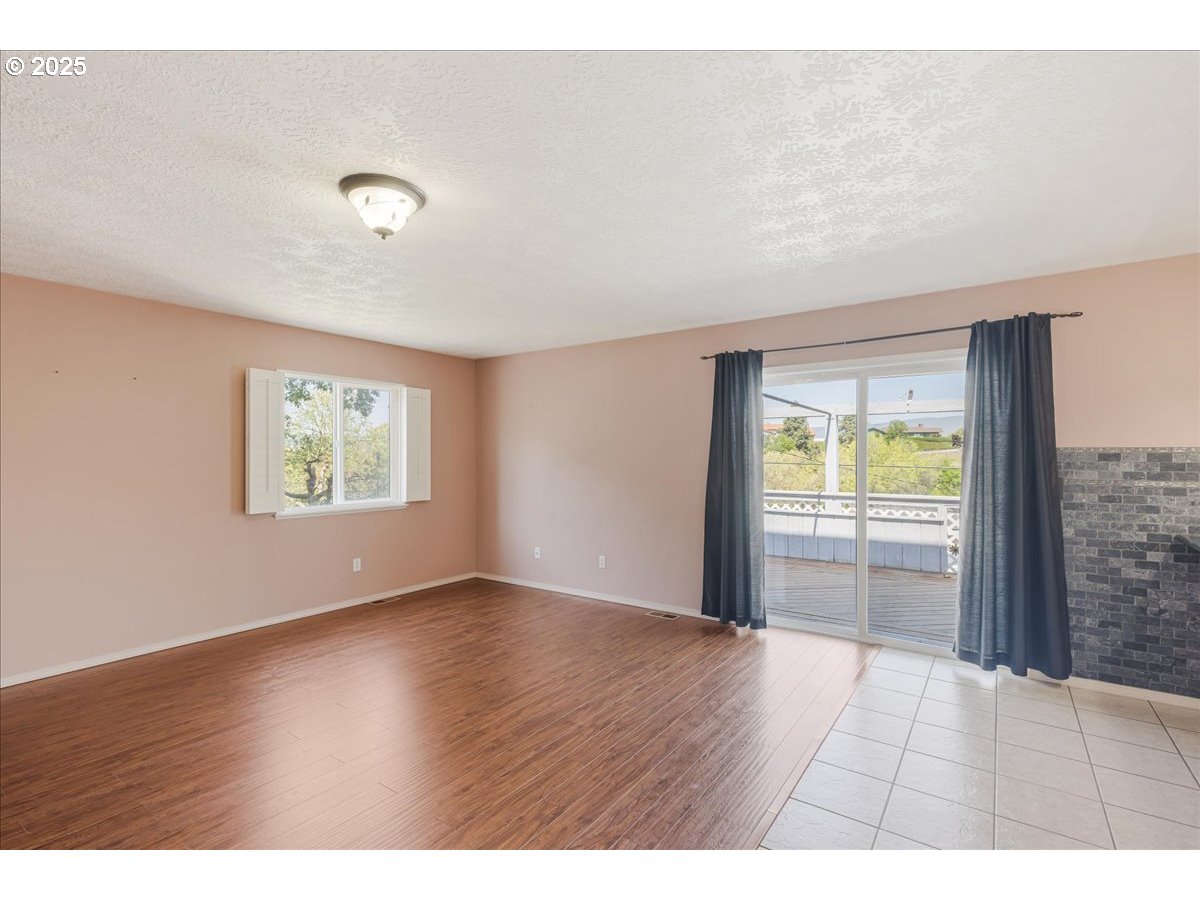 1825 Minnesota Street The Dalles, OR 97058 - Photo 17 of 47 an empty room with wooden floor and windows