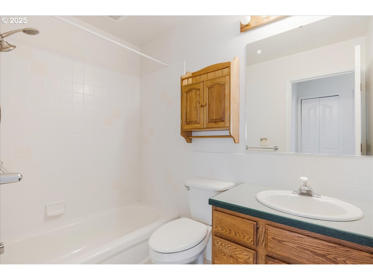 1825 Minnesota Street The Dalles, OR 97058 - Photo 36 of 47 a bathroom with a toilet a sink and mirror
