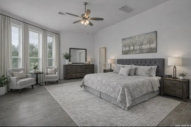 a spacious bedroom with a bed a couch and a large window