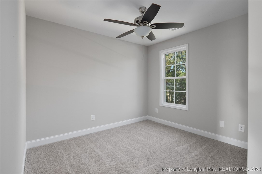 57 3rd Street Parkton, NC 28371 - Photo 13 of 24 an empty room with a window and a fan