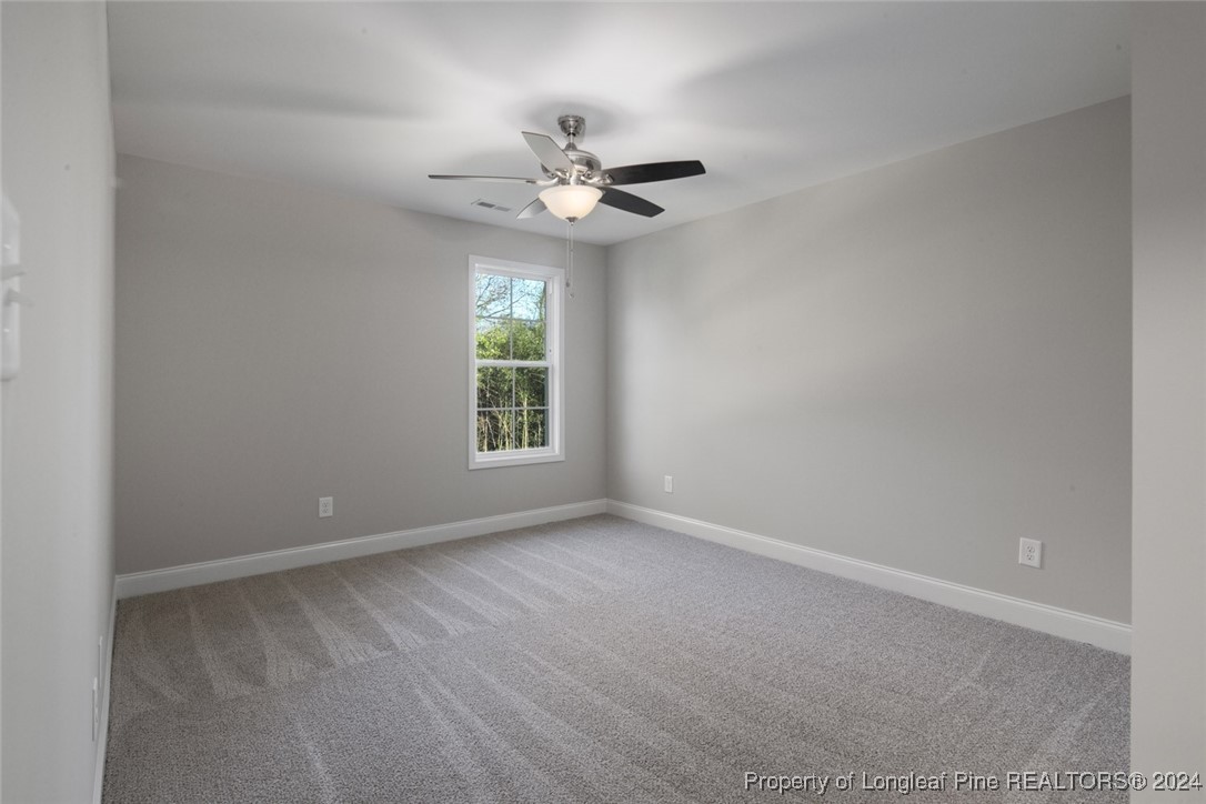 57 3rd Street Parkton, NC 28371 - Photo 15 of 24 an empty room with windows and fan