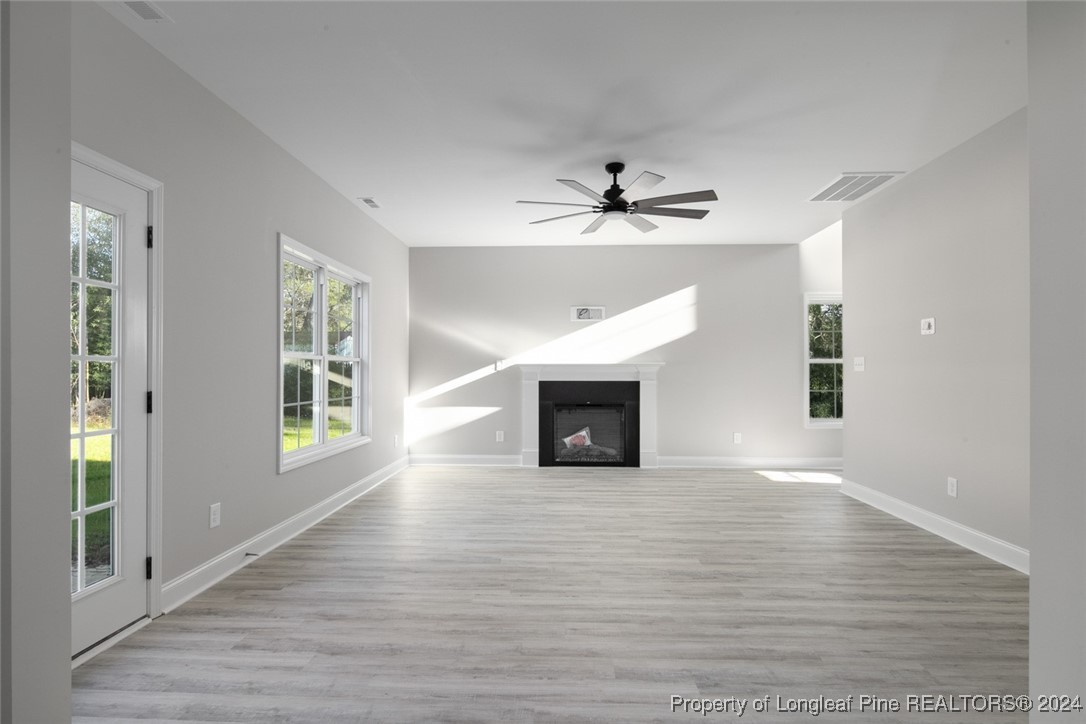 57 3rd Street Parkton, NC 28371 - Photo 6 of 24 a view of an empty room with wooden floor and a window