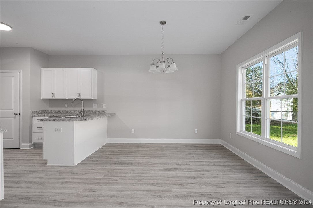 57 3rd Street Parkton, NC 28371 - Photo 7 of 24 a room with a stove a sink and a window