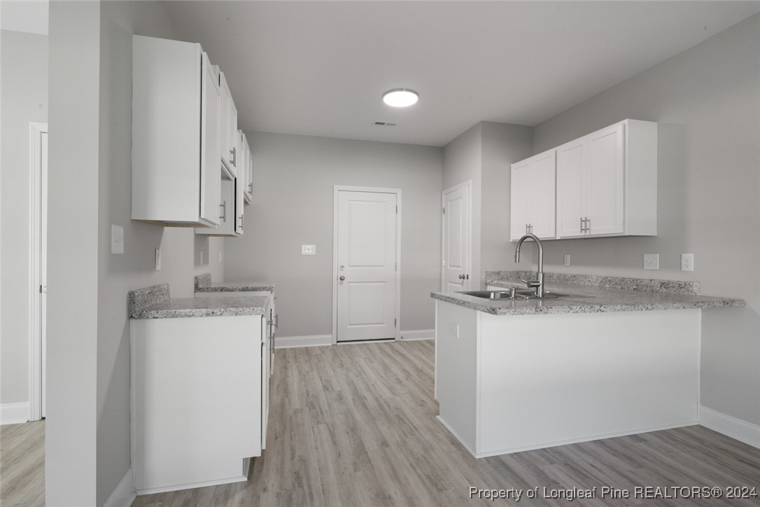 57 3rd Street Parkton, NC 28371 - Photo 9 of 24 a kitchen with granite countertop a sink stove and cabinets