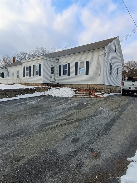 a front view of a house with a road