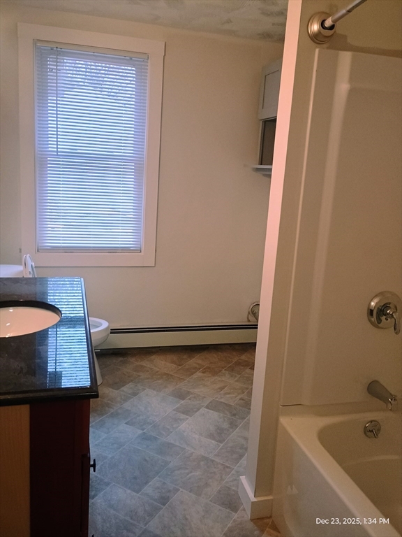 348 Main Street, Unit R Douglas, MA 01516 - Photo 7 of 9 a bathroom with a granite countertop sink and a bathtub