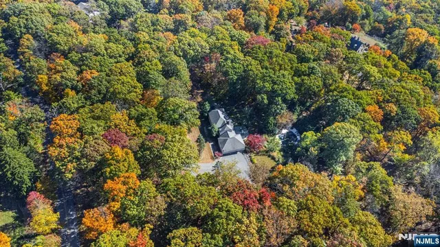 a front view of a house with a yard and large trees