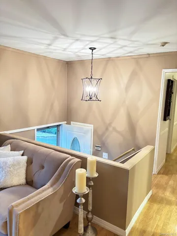 a living room with a couch and a ceiling fan