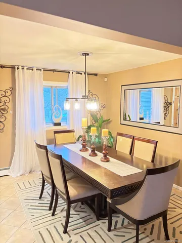 a view of a dining room with furniture and chandelier