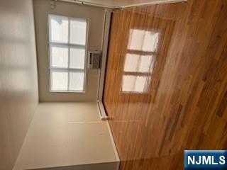 222 Garibaldi Avenue, Unit 47 Lodi, NJ 07644 - Photo 12 of 17 a view of an empty room with wooden floor and a window