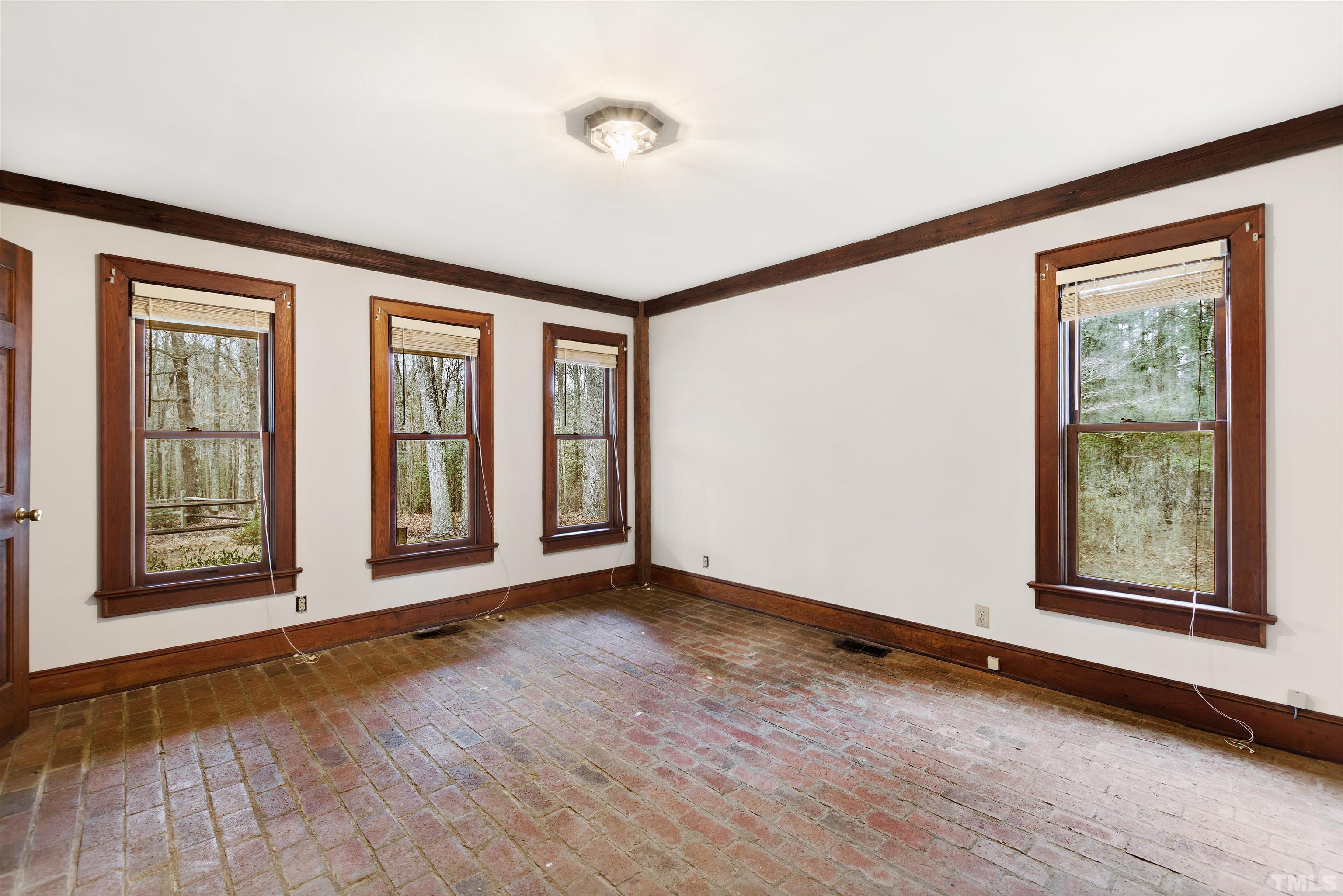 520 Old Stage Road Angier, NC 27501 - Photo 42 of 45 an empty room with wooden floor and windows