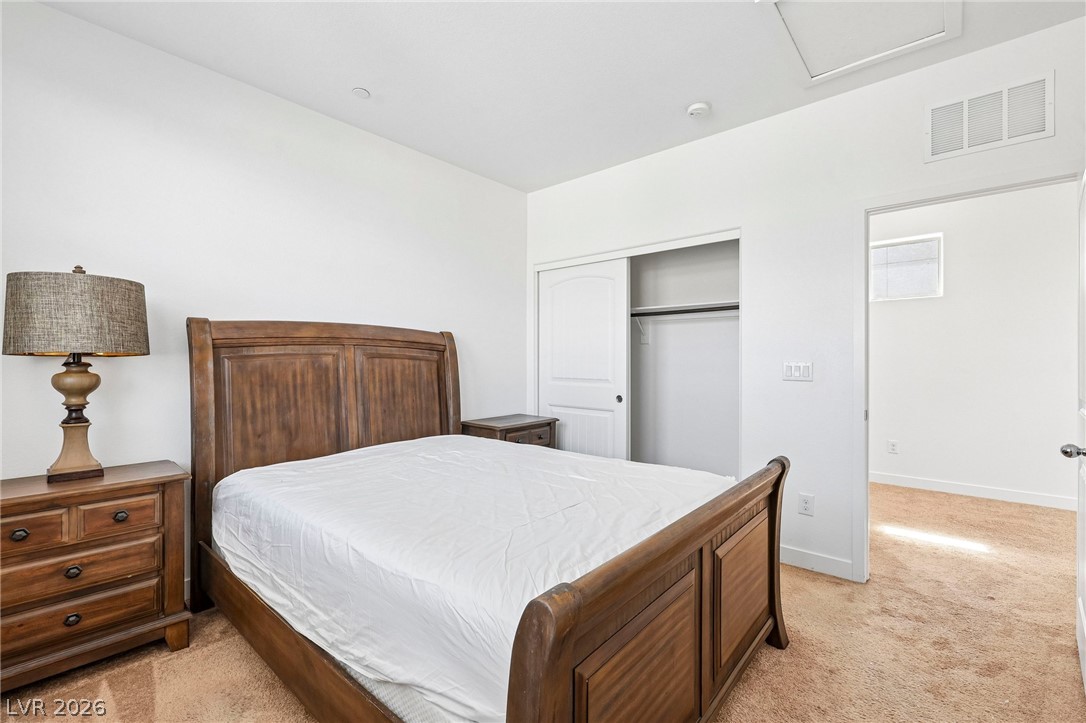 1100 East Sunset Road Henderson, NV 89011 - Photo 35 of 63 Soft carpeting underfoot anchors this quiet sleeping space featuring a convenient built-in closet.