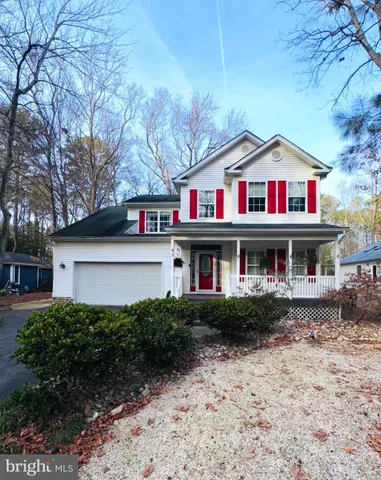 a front view of multi story residential apartment building with yard and sign board