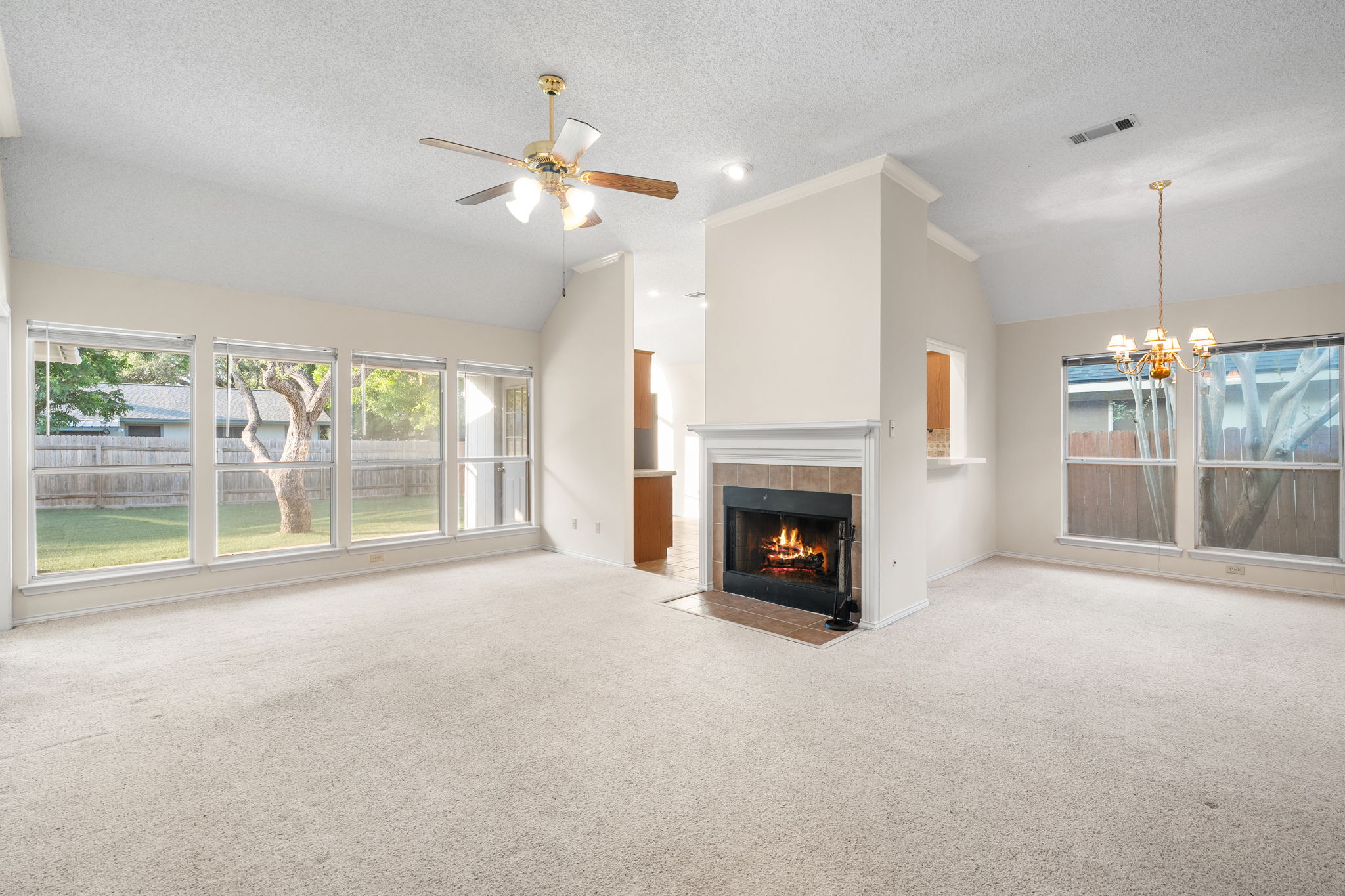 2802 Alexander Drive Leander, TX 78641 - Photo 3 of 29 Living and dining rooms, accented with fireplace and tons of natural light.