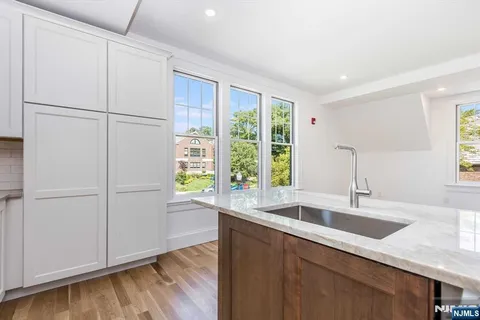 a kitchen with a sink a refrigerator and window