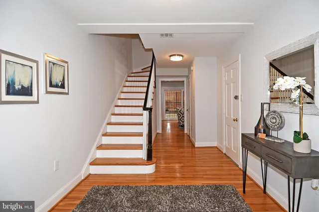 a view of entryway and hall with wooden floor