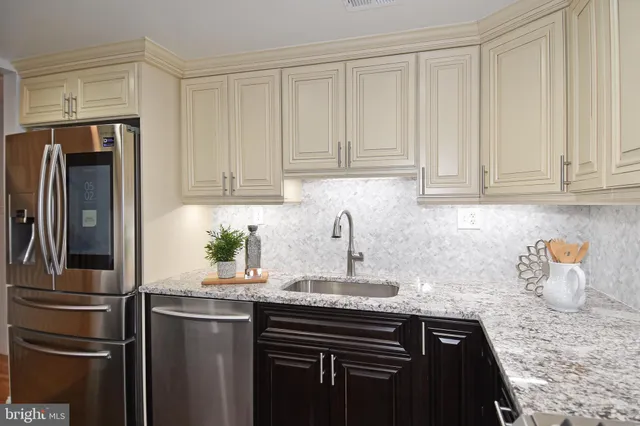 a kitchen with a sink a stove and cabinets