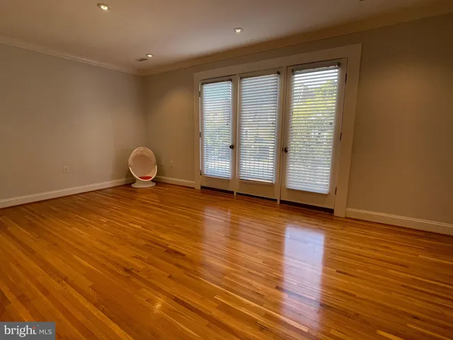a living room with furniture and two large window