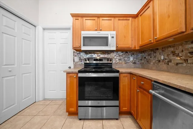 a view of an empty room with a chandelier fan