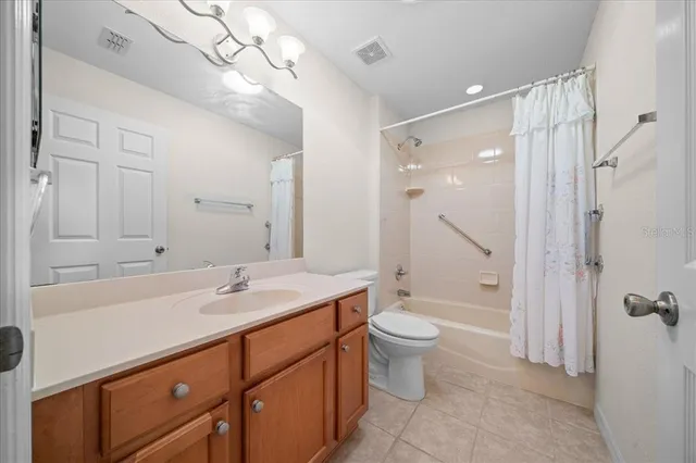 a spacious bathroom with a double vanity sink and a mirror