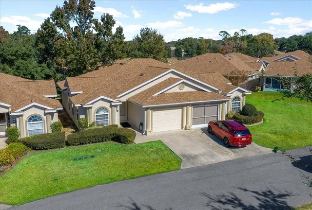 a view of a house with a yard and garage