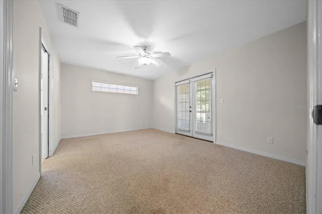 a view of a room with wooden floor and front door