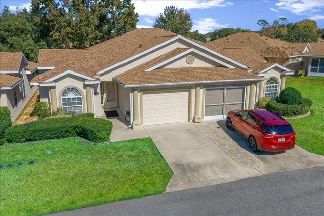 an aerial view of a house with garden space and lake view