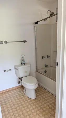 a bathroom with a toilet and a shower