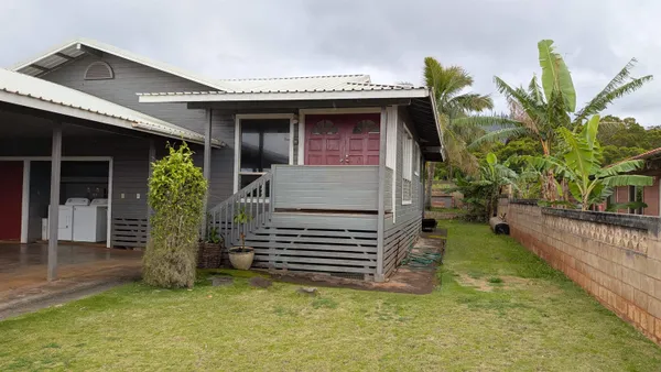 a view of a house with a balcony and stairs