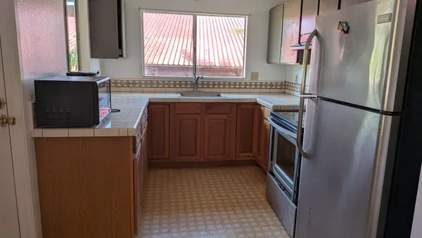 a kitchen with stainless steel appliances a refrigerator and a sink
