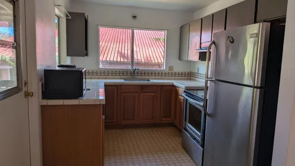a kitchen with a refrigerator sink and stove