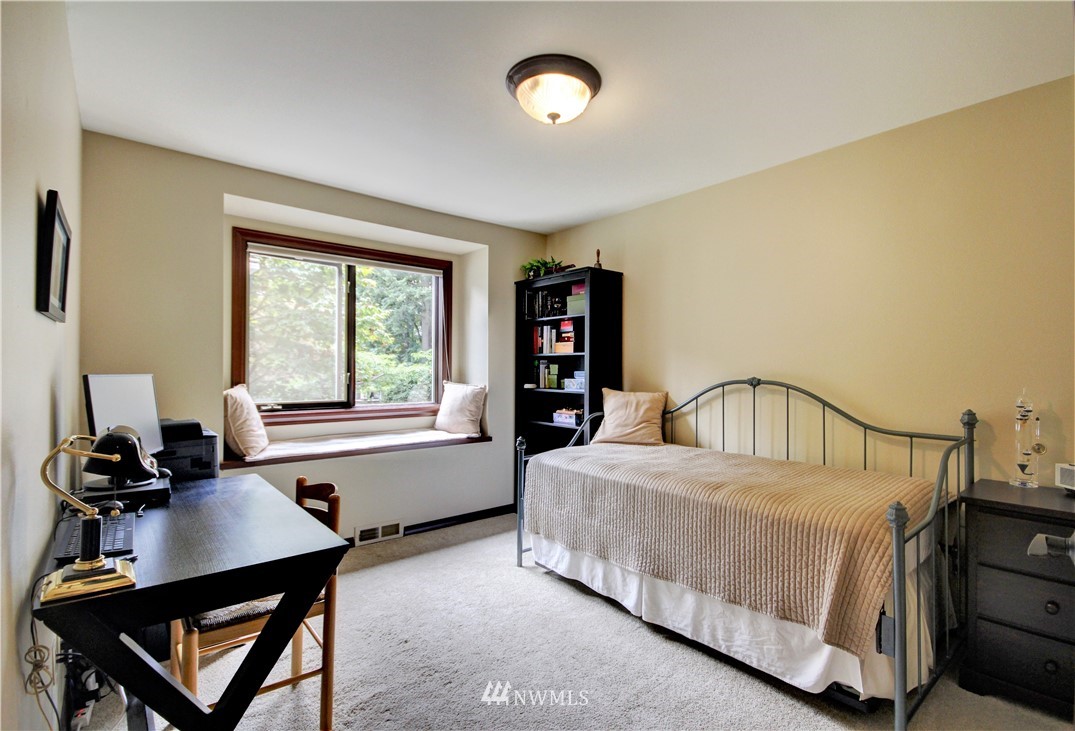 659 Clark Road Bellingham, WA 98225 - Photo 22 of 40 a bedroom with a bed window and a table in it