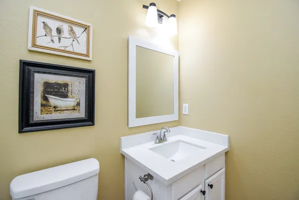 a bathroom with a toilet a sink and a mirror