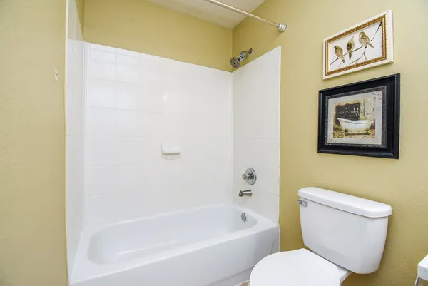 a bathroom with a toilet and a bathtub