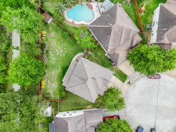 an aerial view of a house with a yard and garden